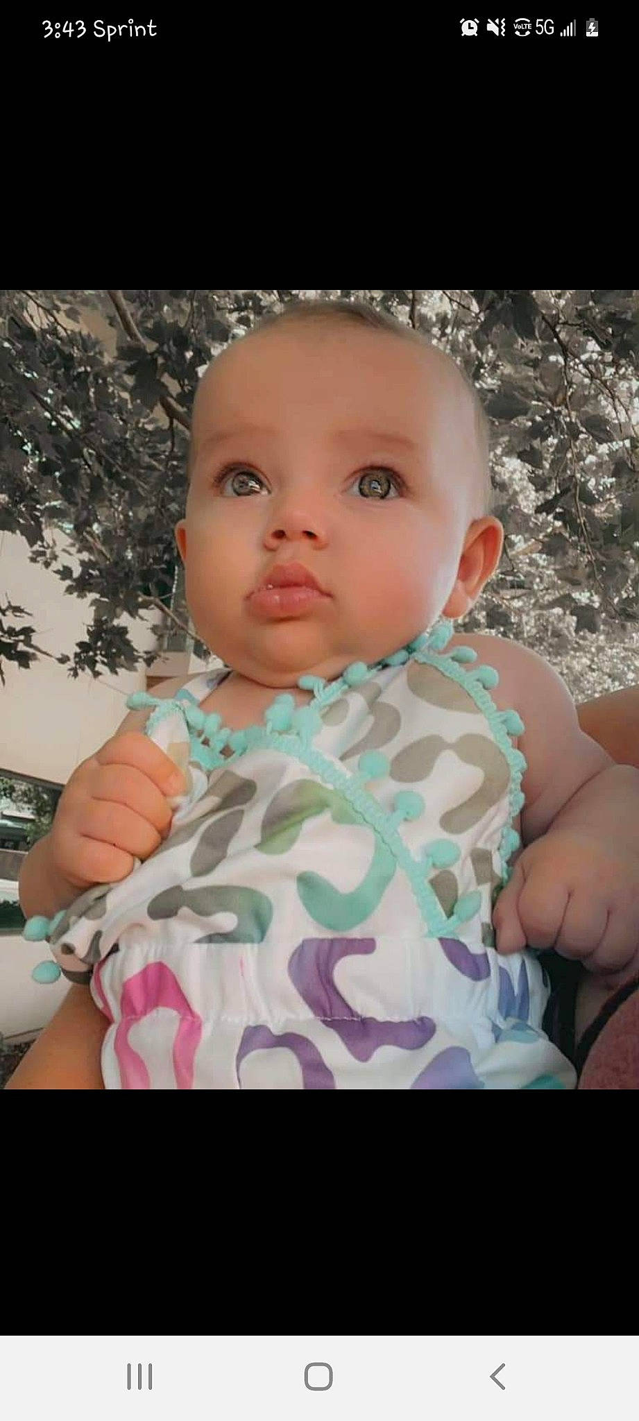 Nyomi is registered to the contest to win money with this photo: arm, baby_toddler_clothing, cheek, chin, dress, eye, eyebrow, eyelash, face, gesture, hand, happy, head, iris, lip, neck, nose, person, shoulder, skin