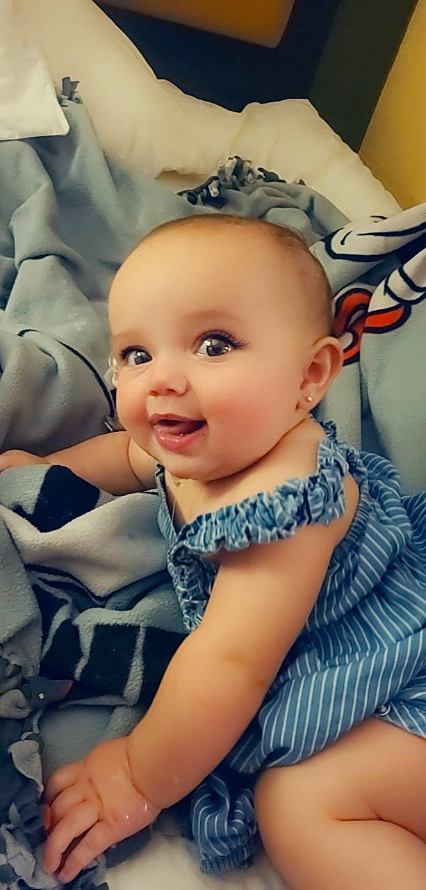 Nyomi is registered to the contest to win money with this photo: azure, baby, baby_toddler_clothing, cheek, child, chin, comfort, electric_blue, eye, eyelash, flash_photography, happy, headpiece, iris, mouth, neck, person, skin, smile, textile