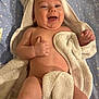 baby, infant, towel, smiling, happy, bare_chest, skin, star_pattern_sheet, bed, lying_down, portrait, open_mouth, hand, thumb_up, chubby_cheeks, soft_towel, bath_time, cute, indoor, closeup