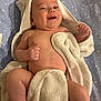 Milo a rejoint le concours — aidez-le/la à gagner de superbes lots ! baby, infant, towel, hood, bath_time, smile, laughing, chubby_legs, bare_torso, blanket, star_pattern, sheet, lying_down, cute, newborn, skin, hand, eyes, mouth, indoor