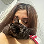 Catdog is registered to the contest to win money with this photo: person, cat, black_cat, pet, indoor, hugging, close_up, paw, fur, face, hair, skin, sleeveless_shirt, white_shirt, red_trim, wall, door, ceiling, affection, playful