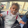 Lissandro participe au concours pour gagner de l'argent avec cette photo : adult, building, car_interior, casual_photo, child, curly_hair, hand, hoodie, inside_car, lap, pacifier, parked_car, portrait, seat, side_mirror, steering_wheel, street, toddler, white_clothing, window
