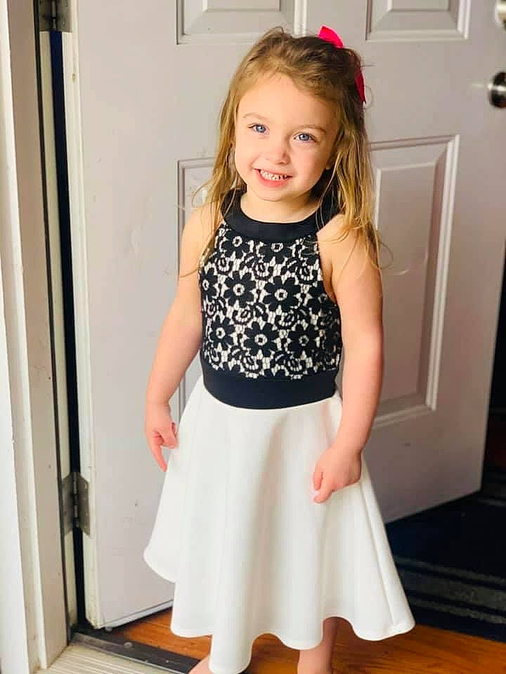 Ramiyah is registered to the contest to win money with this photo: abdomen, day_dress, door, dress, formal_wear, happy, human_leg, joint, joy, knee, neck, pattern, person, pink, shoulder, sleeve, smile, t_shirt, thigh, toddler