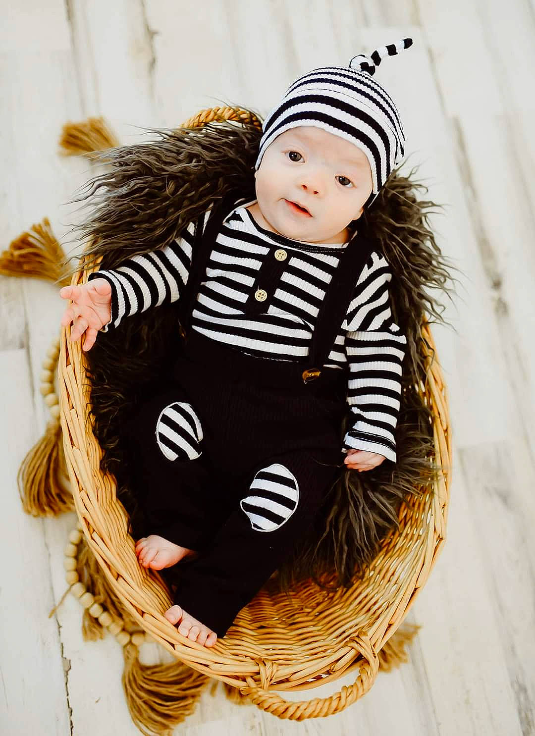 Leonidas is registered to the contest to win money with this photo: arm, baby, baby_toddler_clothing, cap, costume, costume_hat, doll, fashion_accessory, fashion_design, fur, headgear, headwear, jewellery, knit_cap, pattern, person, sitting, sleeve, toddler, toy