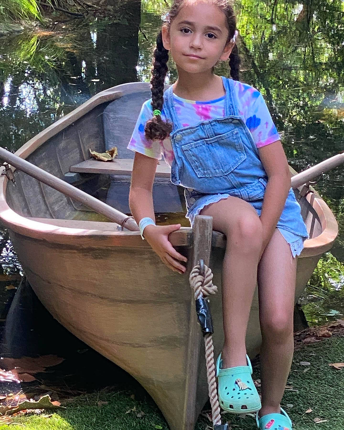 Valentina joined the competition — help win amazing prizes! boat, boats_and_boating_equipment_and_supplies, canoe, child, electric_blue, fun, grass, green, human_leg, joy, jungle, leisure, people_in_nature, person, plant, recreation, sitting, skiff, thigh, tree