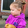 toddler, child, toy, teddy_bear, purple_hoodie, outdoor, brick_wall, door, person, cute, portrait, side_view, young_child, casual_clothing, small_pony_tail, holding, soft_toy, happy_moment, daylight, front_yard