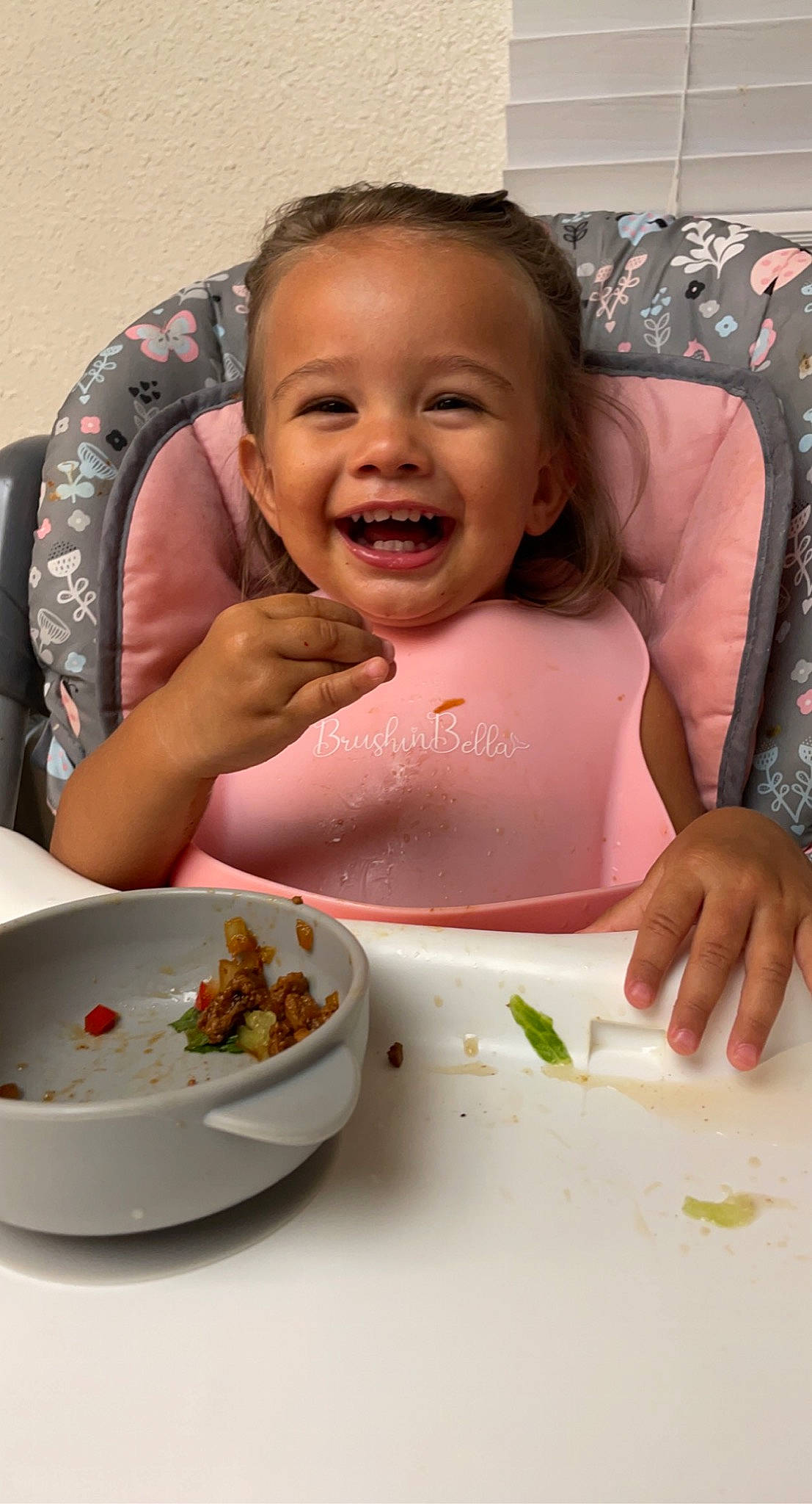 Freya is registered to the contest to win money with this photo: baby, bowl, chair, child, comfort_food, cuisine, dish, dishware, eating, finger, food, food_craving, happy, joy, person, plate, smile, spoon, sweetness, table