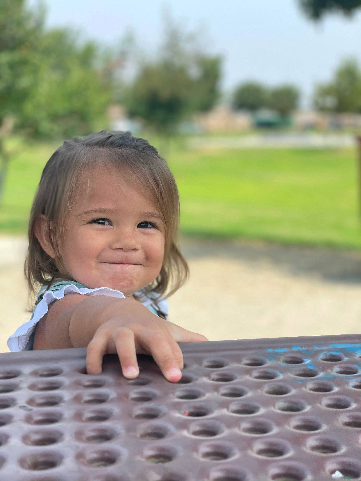 Freya is registered to the contest to win money with this photo: automotive_tire, baby, child, flash_photography, flooring, fun, grass, happy, joy, leisure, person, plant, play, portrait_photography, recreation, sitting, sky, smile, soil, toddler