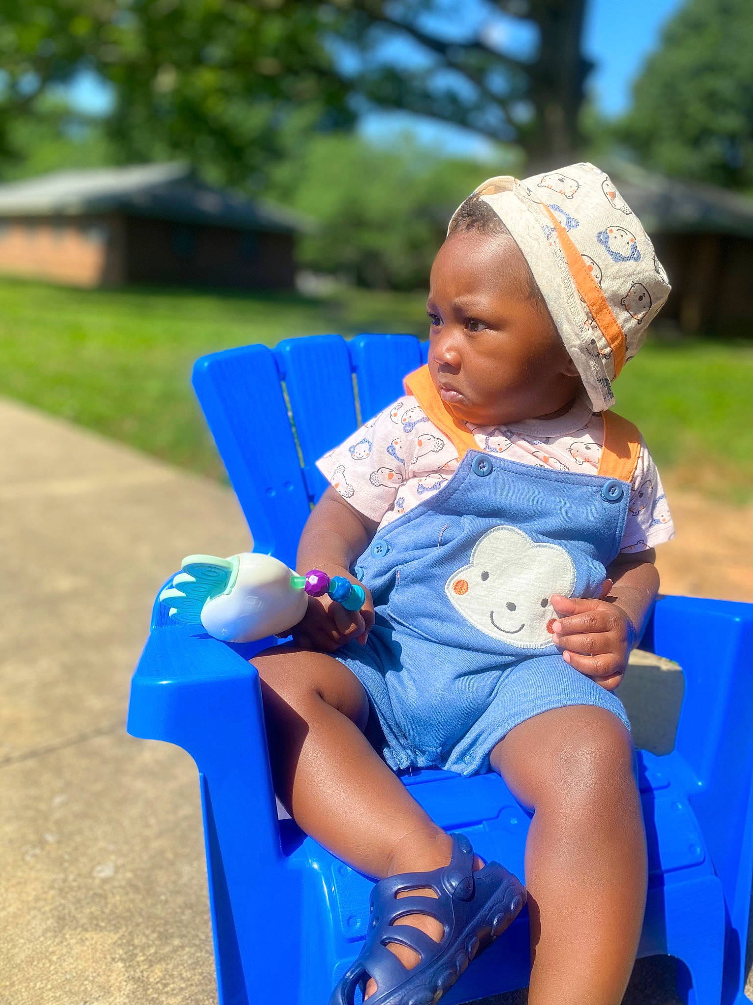 Dante joined the competition — help win amazing prizes! azure, blue, chair, child, electric_blue, event, fun, grass, happy, human_leg, lap, leisure, person, plant, recreation, sandal, sitting, skin, thigh, toddler