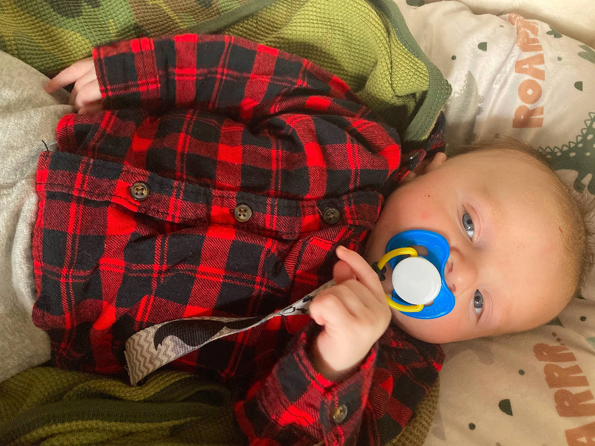 Tyler is registered to the contest to win money with this photo: baby, baby_products, baby_sleeping, baby_toddler_clothing, bedding, bedtime, cheek, child, comfort, eyelash, linens, nail, pattern, person, plaid, red, sleeve, tartan, textile, toddler