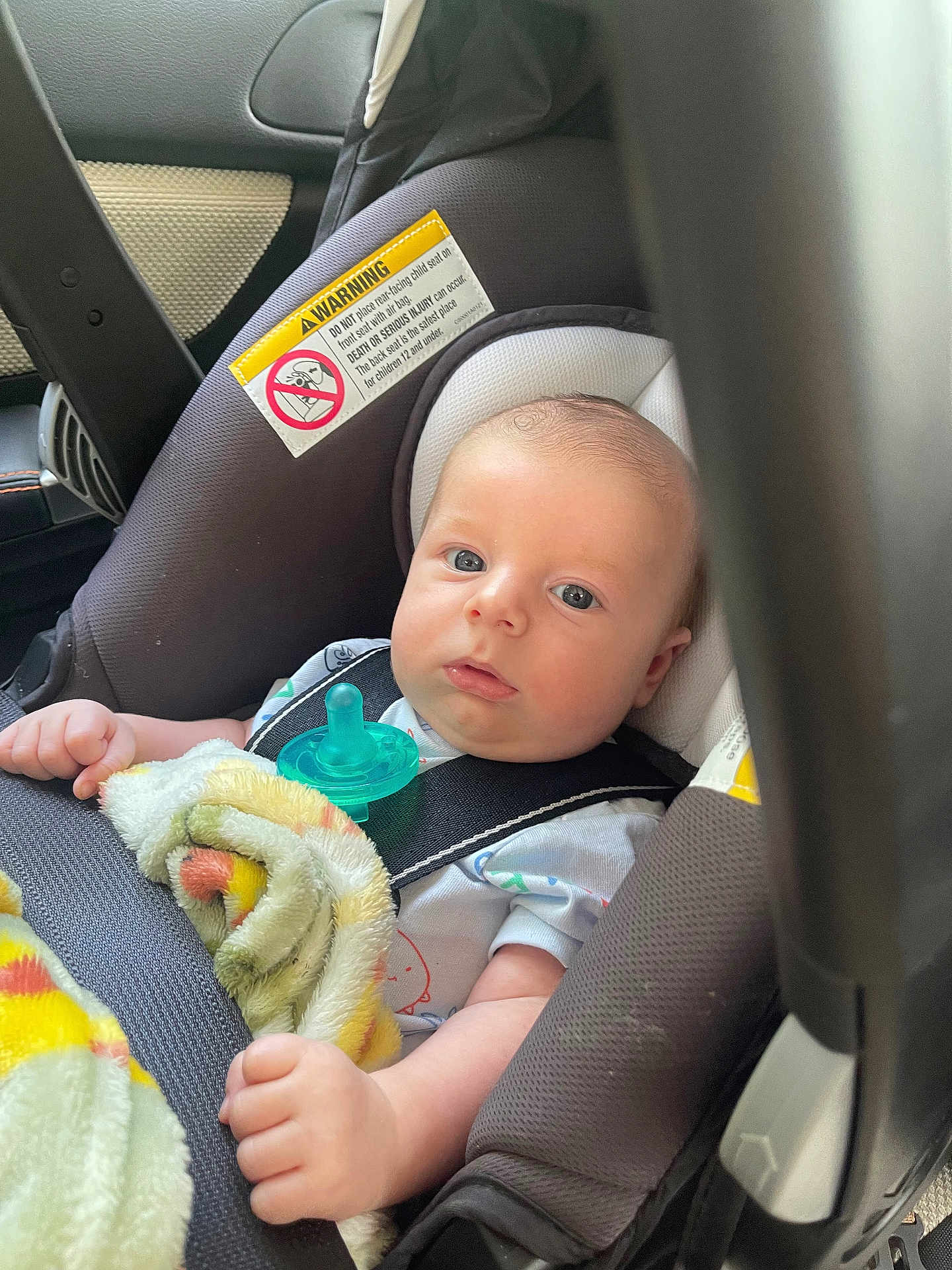 Oliver joined the competition — help win amazing prizes! baby, car_seat, blanket, pacifier, infant, child, seatbelt, safety, warning_label, clothing, hand, face, head, blue_eyes, indoor, transportation, car, cute, newborn, portrait