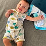 arm, baby, blanket, blue, child, cute, face, fish_pattern, foot, happy, head, indoors, infant, leg, lying_down, romper, skin, smiling, soft_surface, white
