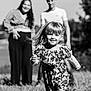 child, girl, running, smiling, outdoor, family, people, woman, man, dress, pigtails, grass, nature, happy, sunlight, black_and_white, portrait, adult, blurred_background, field