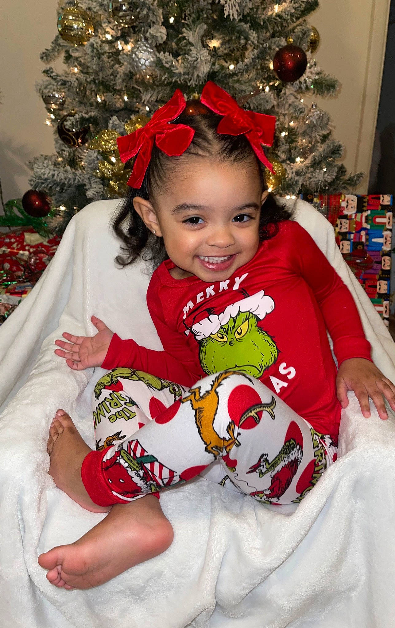 Mikaela joined the competition — help win amazing prizes! baby_toddler_clothing, beauty, child, christmas_decoration, christmas_ornament, christmas_tree, event, face, facial_expression, fun, happy, head, holiday, joy, person, plant, red, sleeve, smile, toddler