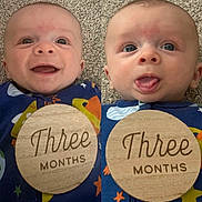Gabriel is registered to the contest to win money with this photo: baby, blue_clothing, carpet, child, closeup, cute, expression, face, happy, head, infant, lying_down, onesie, playful, portrait, smiling, space_theme, three_months, tongue_out, wooden_plaque