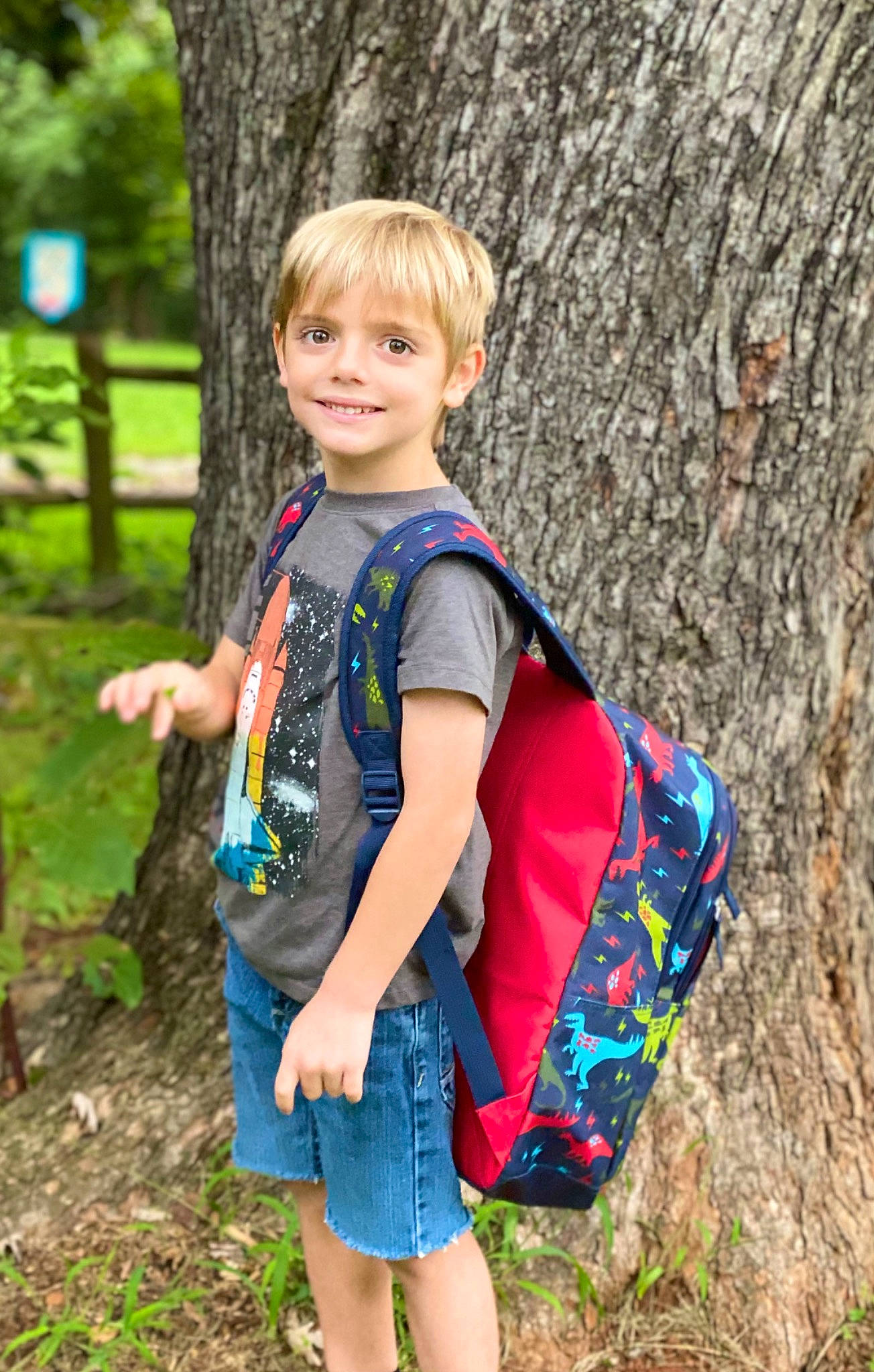 Eli joined the competition — help win amazing prizes! clothing, denim, electric_blue, fun, grass, happy, joy, leisure, people_in_nature, person, plant, recreation, shorts, sleeve, smile, standing, t_shirt, toddler, tree, trunk