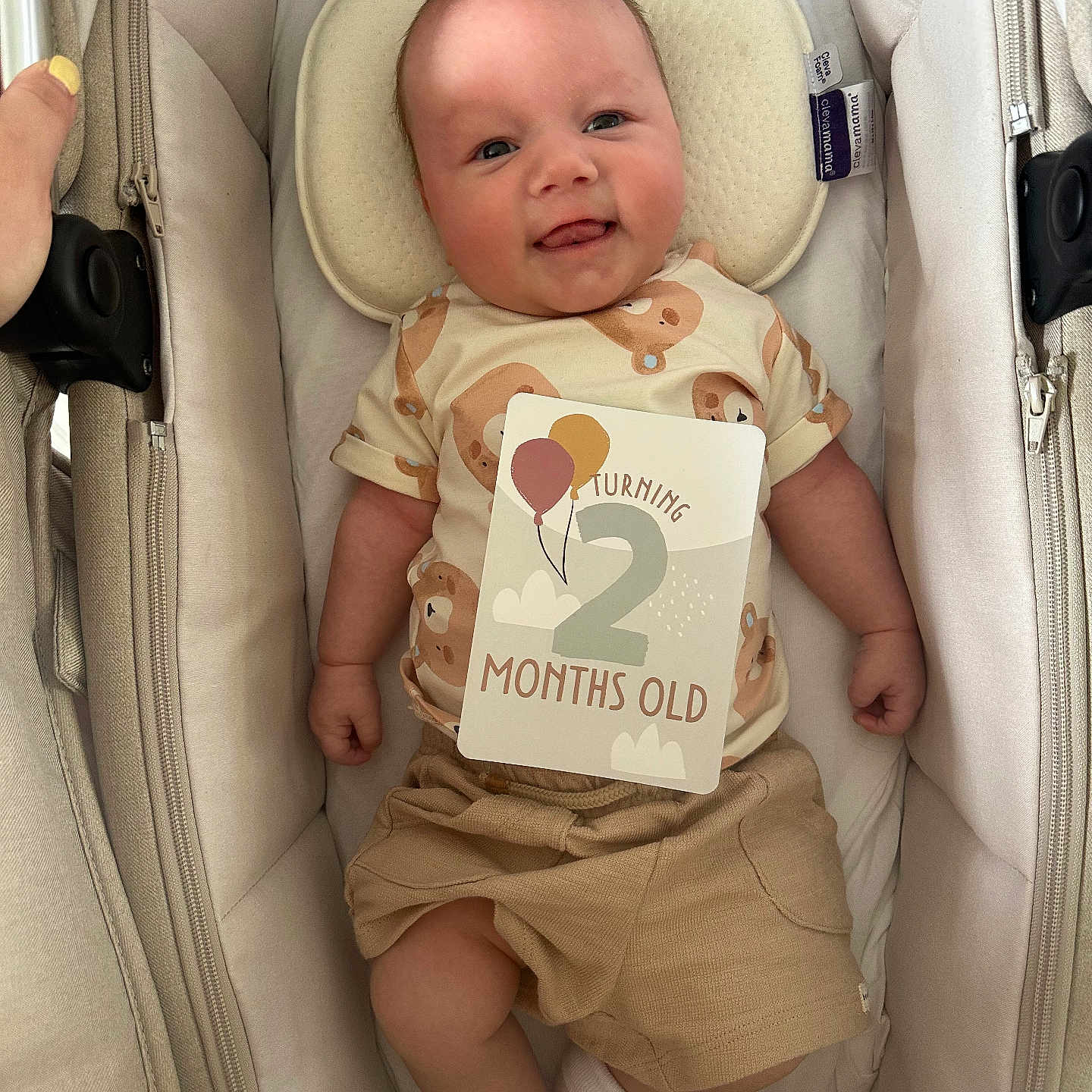 Trent is registered to the contest to win money with this photo: baby, balloons, bassinet, card, clothing, cute, fabric, face, hand, happy, indoor, infant, lying_down, newborn, person, pillow, shorts, smiling, sock, text