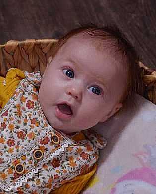 Hazel is registered to the contest to win money with this photo: baby, baby_toddler_clothing, cheek, child, comfort, eye, eyebrow, happy, head, human_body, iris, lip, mouth, nose, person, skin, sleeve, smile, surprise, textile