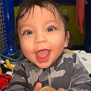 Niko joined the competition — help win amazing prizes! toddler, child, smiling, blue_eyes, wet_hair, toy, cookie_toy, camo_jacket, indoor, play_area, happy, close_up, portrait, cute, baby, hands, expression, face, person, young_child