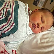 Juniper joined the competition — help win amazing prizes! newborn, baby, infant, swaddled, sleeping, face, cheeks, pillow, blanket, striped_blanket, bed, hospital_room, closed_eyes, lips, peaceful, portrait, closeup, skin, head, newborn_wrapping