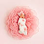 baby, newborn, infant, swaddled, headband, bow, floral_swaddle, pink, tulle, ruffles, blanket, sleeping, portrait, studio, soft_light, top_view, flower, delicate, peaceful, one_person