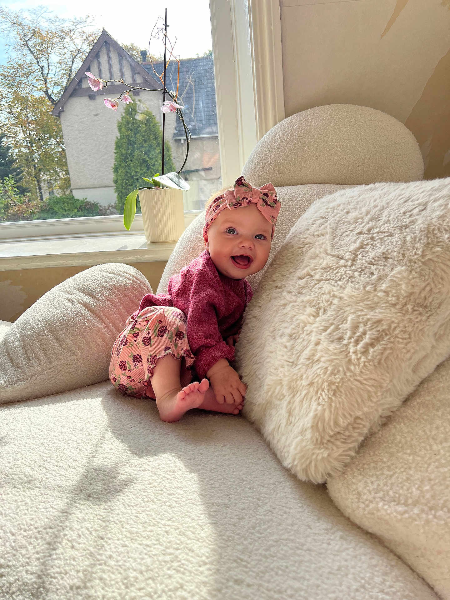 Alana Rae joined the competition — help win amazing prizes! baby, infant, smiling, headband, pink_clothing, flower, orchid, plant, window, sunlight, cozy, furniture, cushion, indoor, child, happy, cute, portrait, soft_texture, home