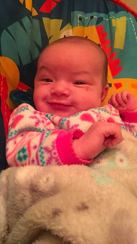 Mersadies is registered to the contest to win money with this photo: baby, cheek, child, eye, face, facial_expression, forehead, head, joy, lip, mouth, nose, person, pink, product, skin, smile, textile, toddler