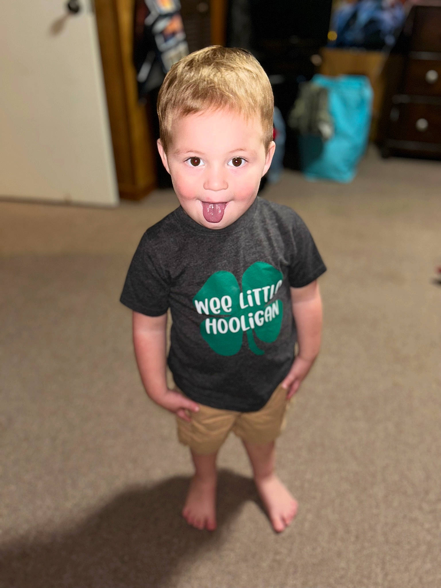 Koda is registered to the contest to win money with this photo: baby_toddler_clothing, cabinetry, child, event, eye, floor, flooring, fun, hair, hairstyle, happy, hardwood, head, human_leg, joint, person, sitting, sleeve, t_shirt, toddler