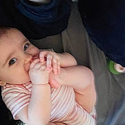 Daevii Lee is registered to the contest to win money with this photo: baby, infant, foot, hand, onesie, striped_clothing, cute, child, mouthing, skin, person, looking, indoors, soft_lighting, candid, exploration, flexibility, young_child, adorable, closeup