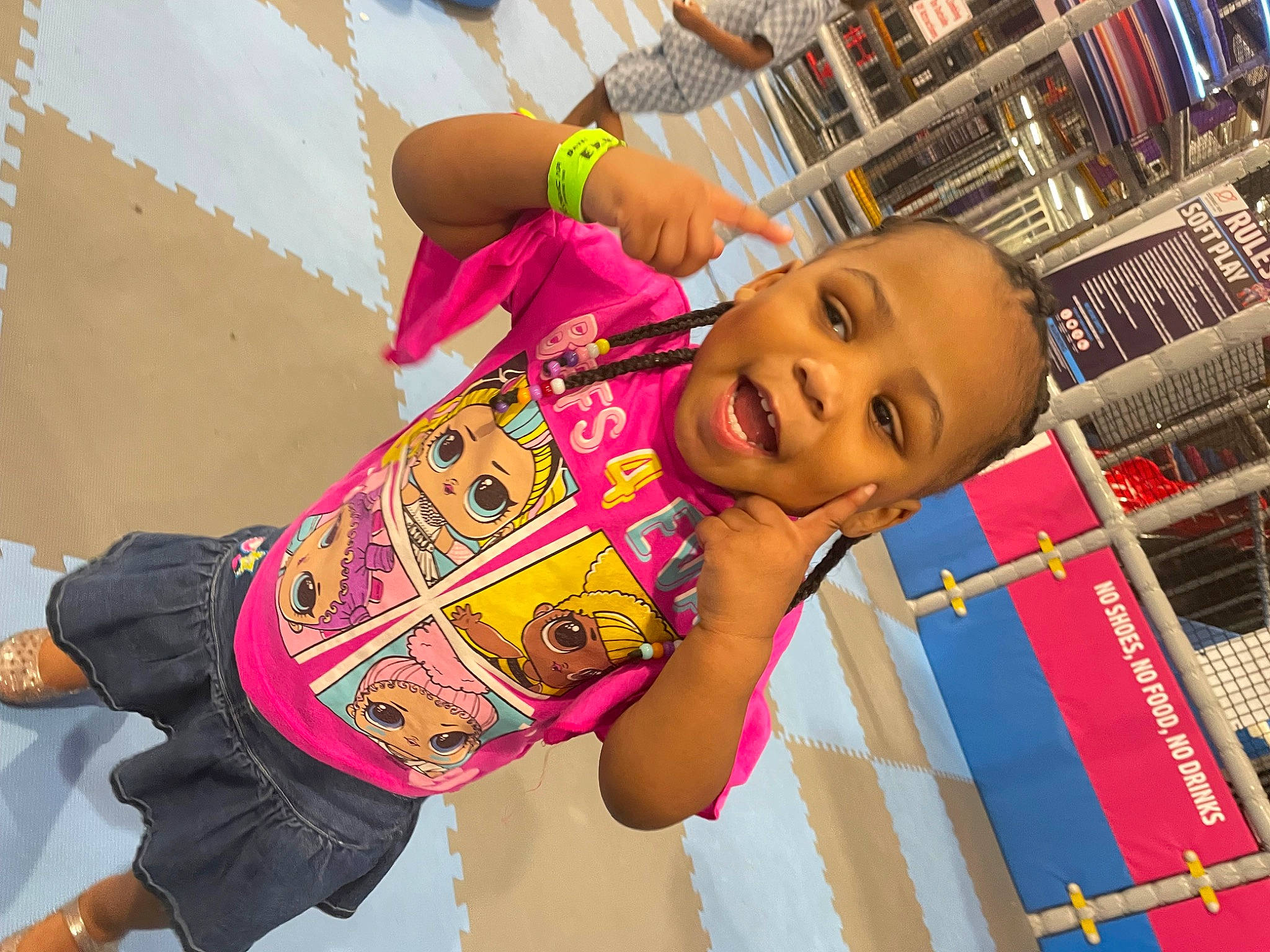 Nevaeh is registered to the contest to win money with this photo: bookcase, building, child, customer, fun, happy, leisure, magenta, pattern, person, play, publication, retail, room, shelf, shelving, shopping, smile, t_shirt, thigh