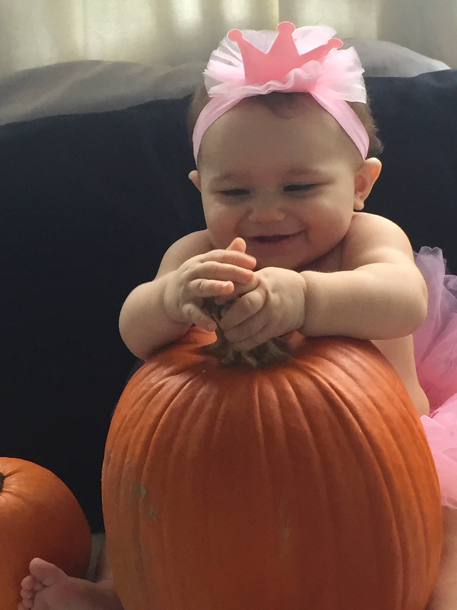 Lailani is registered to the contest to win money with this photo: baby, calabaza, child, cucurbita, face, hair_accessory, head, person, pink, pumpkin, toddler, winter_squash