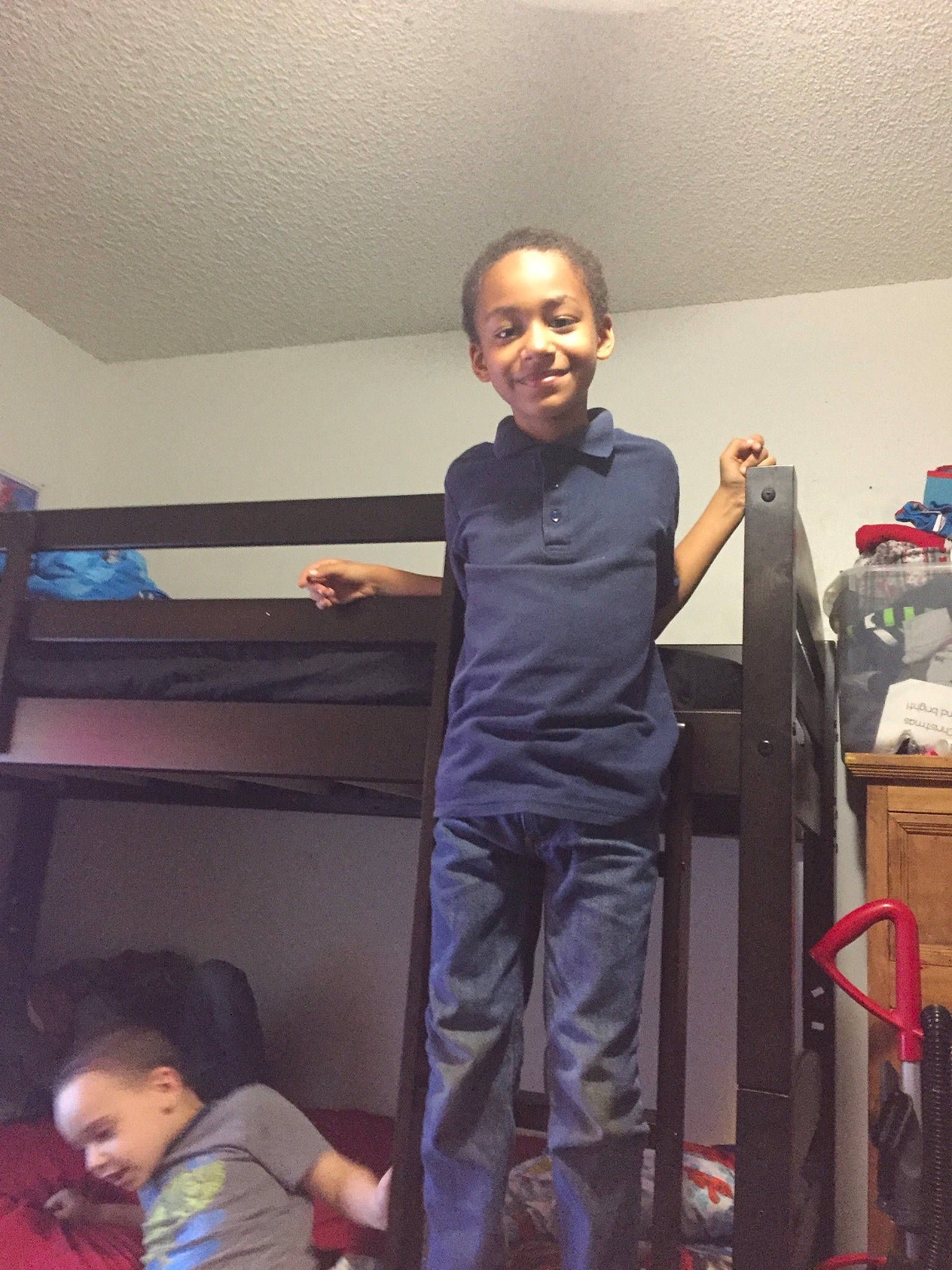 Jayden is registered to the contest to win money with this photo: arm, child, electronic_device, fun, glasses, joint, joy, person, room, shoulder, standing, t_shirt