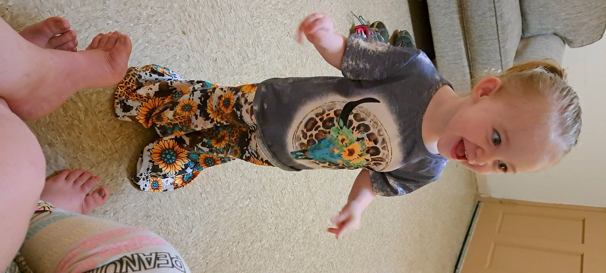 Lillian is registered to the contest to win money with this photo: baby, calf, child, foot, fun, human_leg, knee, leisure, nail, pattern, person, recreation, sitting, skateboard, smile, sock, thigh, toddler, tree, visual_arts