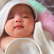 Sidak is registered to the contest to win money with this photo: baby, infant, towel, blanket, soft_texture, hood, sleepy, chubby_cheeks, close_up, portrait, cute, skin, indoors, resting, comfortable, young_child, head_covering, peaceful, warm, cozy