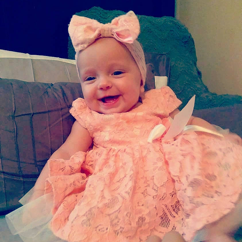 Emmalyn joined the competition — help win amazing prizes! baby, cheek, child, dress, ear, eye, hair_accessory, head, iris, joy, peach, person, pink, skin, smile, textile, toddler