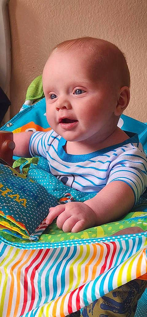 Jimmy is registered to the contest to win money with this photo: azure, baby, baby_toddler_clothing, blue, cheek, child, electric_blue, finger, fun, grass, happy, iris, linens, pattern, person, sitting, skin, sleeve, smile, t_shirt