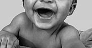 Kai Eli is registered to the contest to win money with this photo: animal_print, arm, baby, black_and_white, child, closeup, cushion, cute, expression, eyes, face, hand, happy, indoor, infant, mouth, pattern, portrait, skin, smile