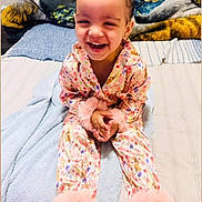 Makayla Gisela joined the competition — help win amazing prizes! bed, blanket, child, clothing, colorful, cozy, cute, face, fluffy, fun, hair, happy, indoor, joyful, pajamas, person, portrait, sitting, smiling, toddler
