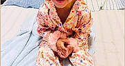 Makayla Gisela joined the competition — help win amazing prizes! bed, blanket, child, clothing, colorful, cozy, cute, face, fluffy, fun, hair, happy, indoor, joyful, pajamas, person, portrait, sitting, smiling, toddler