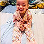 bed, blanket, child, clothing, colorful, cozy, cute, face, fluffy, fun, hair, happy, indoor, joyful, pajamas, person, portrait, sitting, smiling, toddler