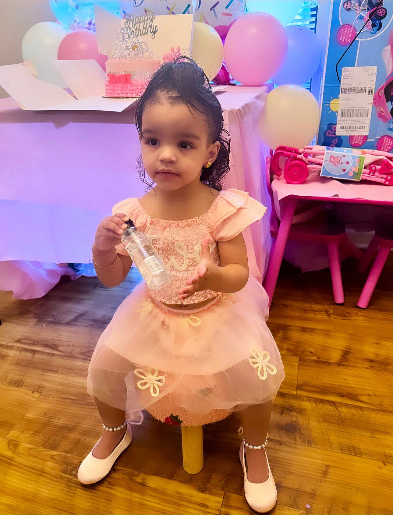 Makayla Gisela is registered to the contest to win money with this photo: child, girl, birthday, party, pink_dress, balloons, cake, table, floor, wood_floor, shoes, pearl_anklet, toy, chair, happy, cute, indoors, celebration, face, small_stool