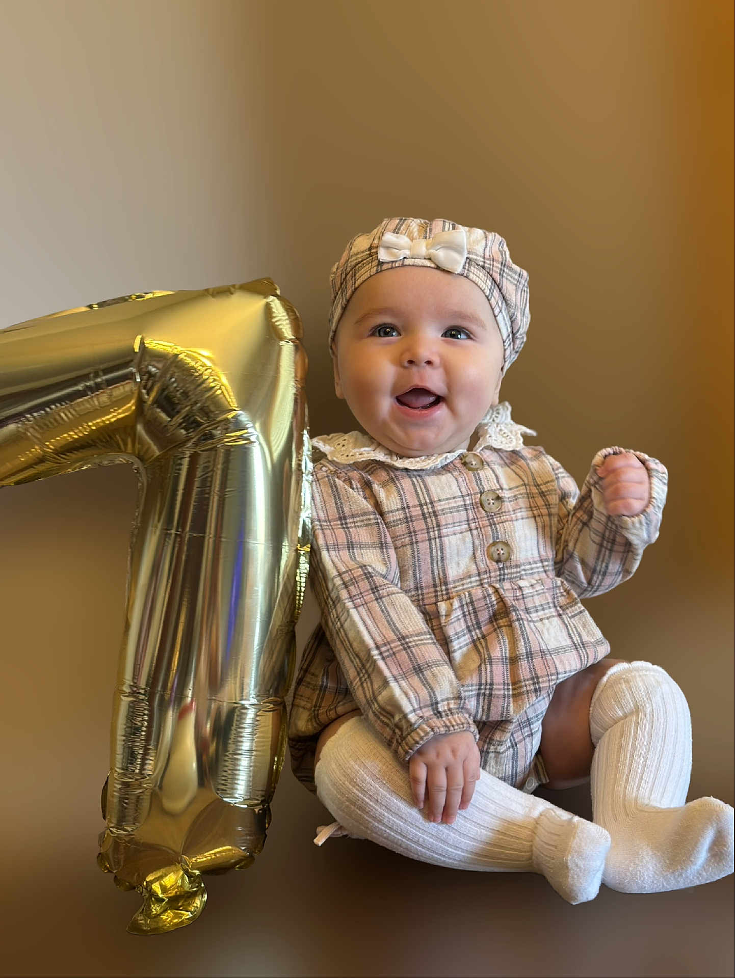 Azalea joined the competition — help win amazing prizes! baby, child, plaid_clothing, hat, white_socks, balloon, number_one, celebration, smile, happy, portrait, sitting, cute, infant, first_birthday, indoors, baby_girl, clothing, face, headwear