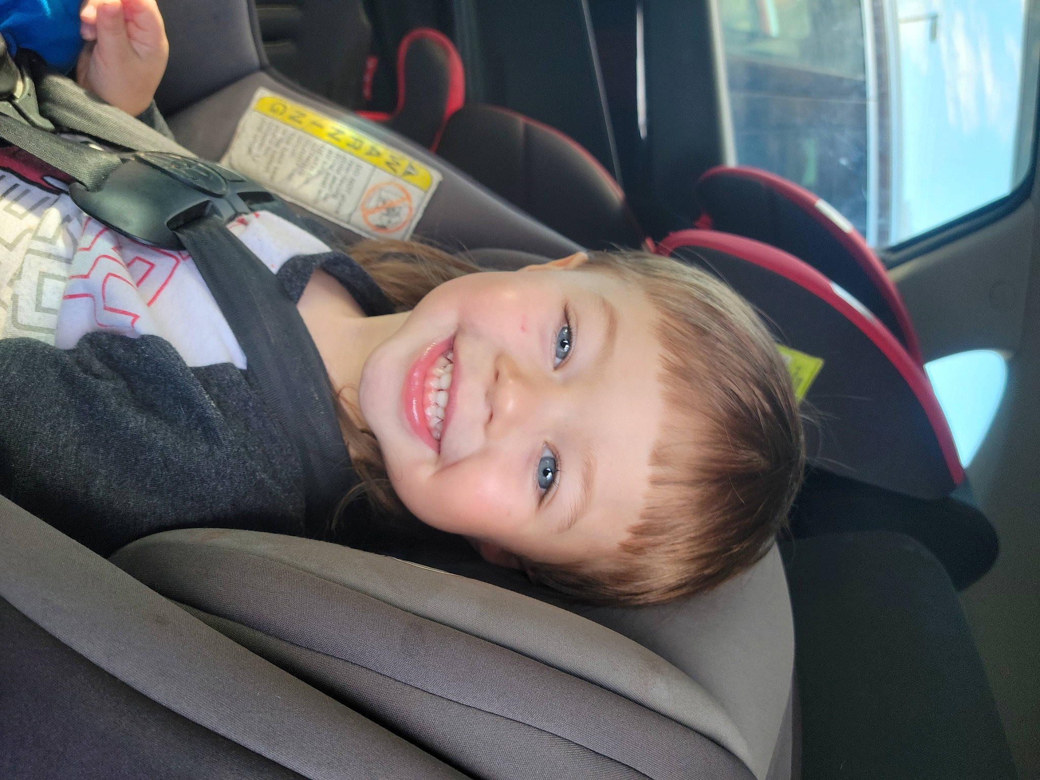 Jameson is registered to the contest to win money with this photo: auto_part, automotive_design, automotive_exterior, car, car_seat, car_seat_cover, child, comfort, family_car, fun, hairstyle, joy, luxury_vehicle, motor_vehicle, person, smile, steering_part, toddler, tree, vehicle