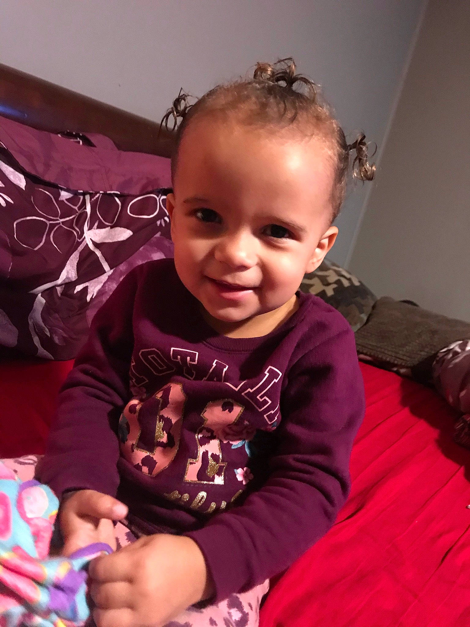 Egypt is registered to the contest to win money with this photo: baby, baby_toddler_clothing, cheek, child, eye, face, finger, fun, hair, hand, happy, head, joy, organ, person, pink, purple, skin, sleeve, smile