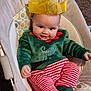 Isla-May joined the competition — help win amazing prizes! baby, baby_seat, carpet, child, cozy, cushion, cute, festive, green_top, happy, holiday_clothing, indoors, infant, person, plush, portrait, red_and_white, smiling, striped_pants, yellow_crown