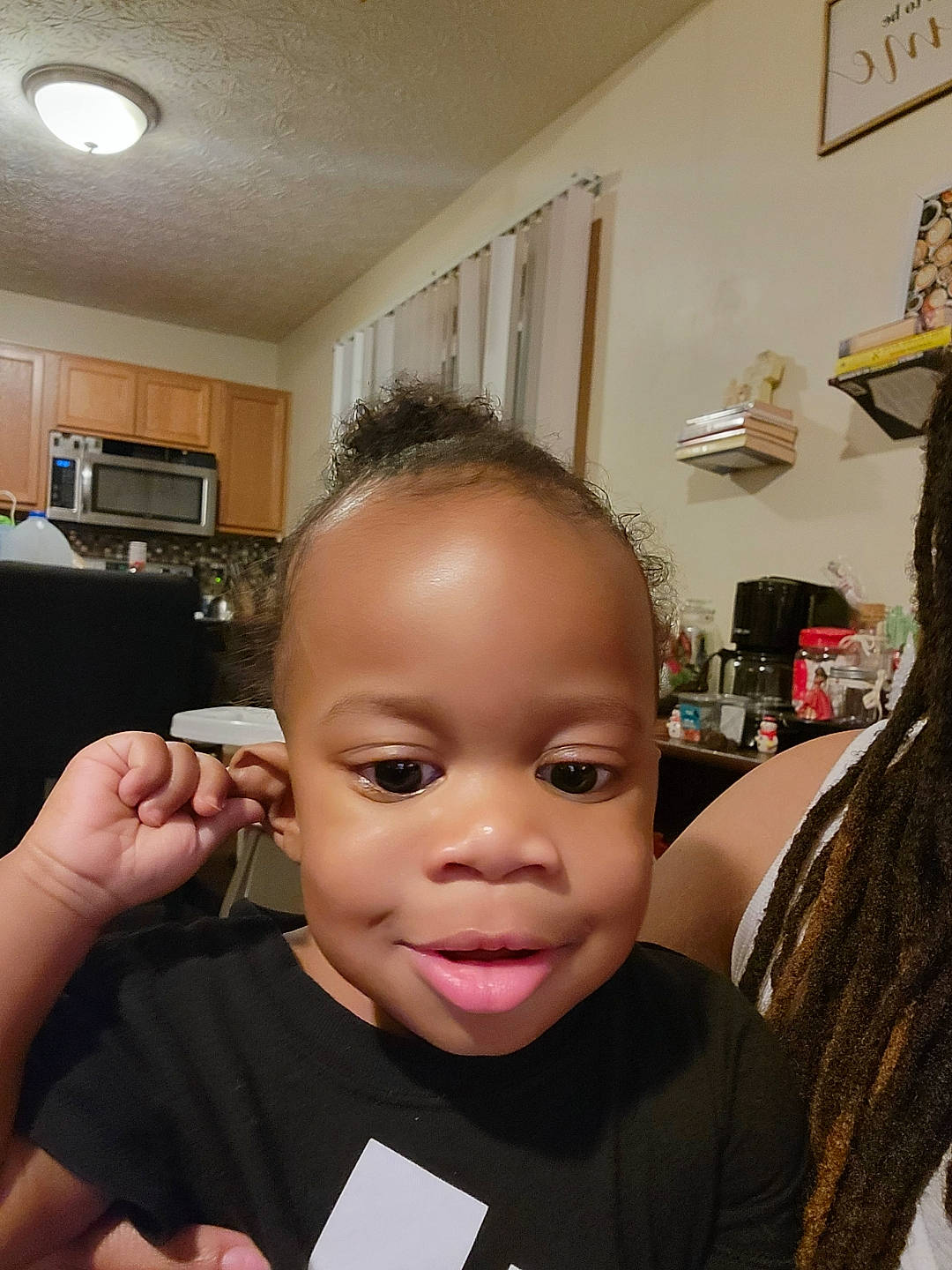 Ezra is registered to the contest to win money with this photo: baby, beauty_salon, black_hair, chair, cheek, chin, ear, eyebrow, eyelash, forehead, gesture, hairstyle, happy, lip, nose, person, personal_grooming, picture_frame, skin, smile