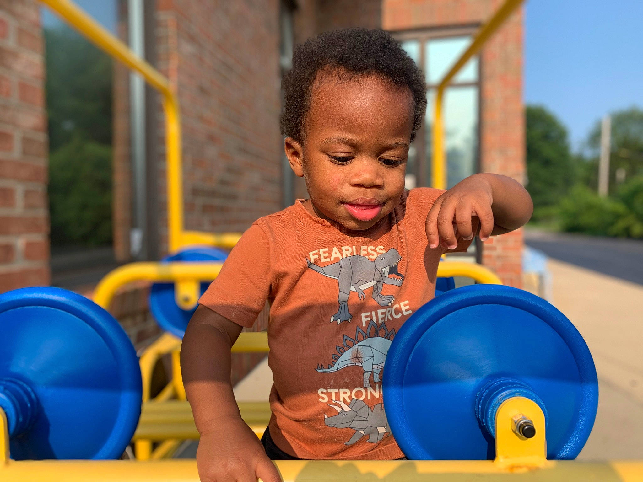 Ezra is registered to the contest to win money with this photo: baby_playing_with_toys, baby_toddler_clothing, child, city, electric_blue, fun, gas, happy, leisure, outdoor_play_equipment, person, plastic, play, recreation, sitting, sky, t_shirt, toddler, tree, vacation
