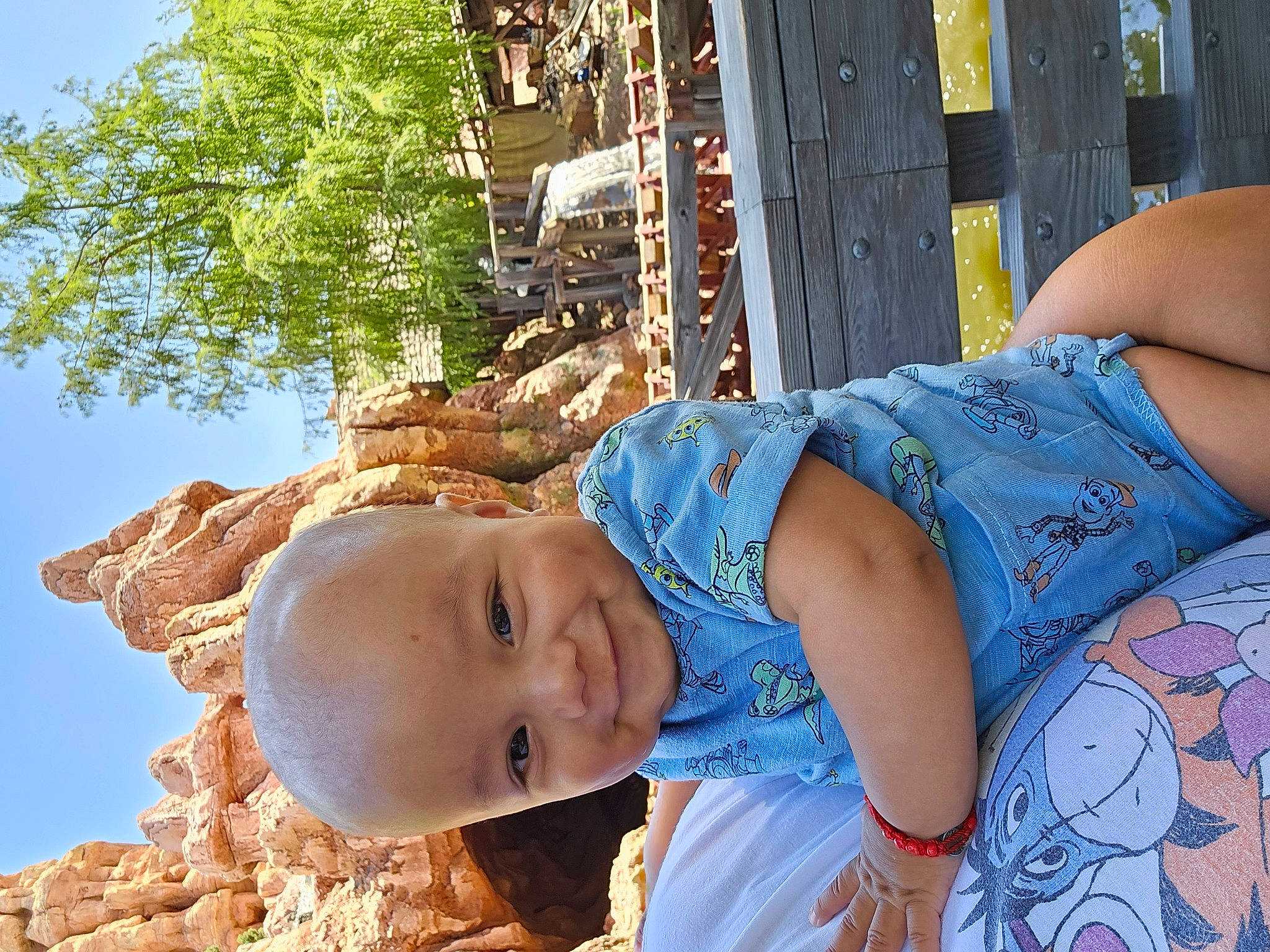 Aiden is registered to the contest to win money with this photo: child, electric_blue, fun, happy, hat, human_body, human_leg, leisure, people_in_nature, person, plant, sitting, sky, smile, summer, thigh, toddler, tree, trunk, wood