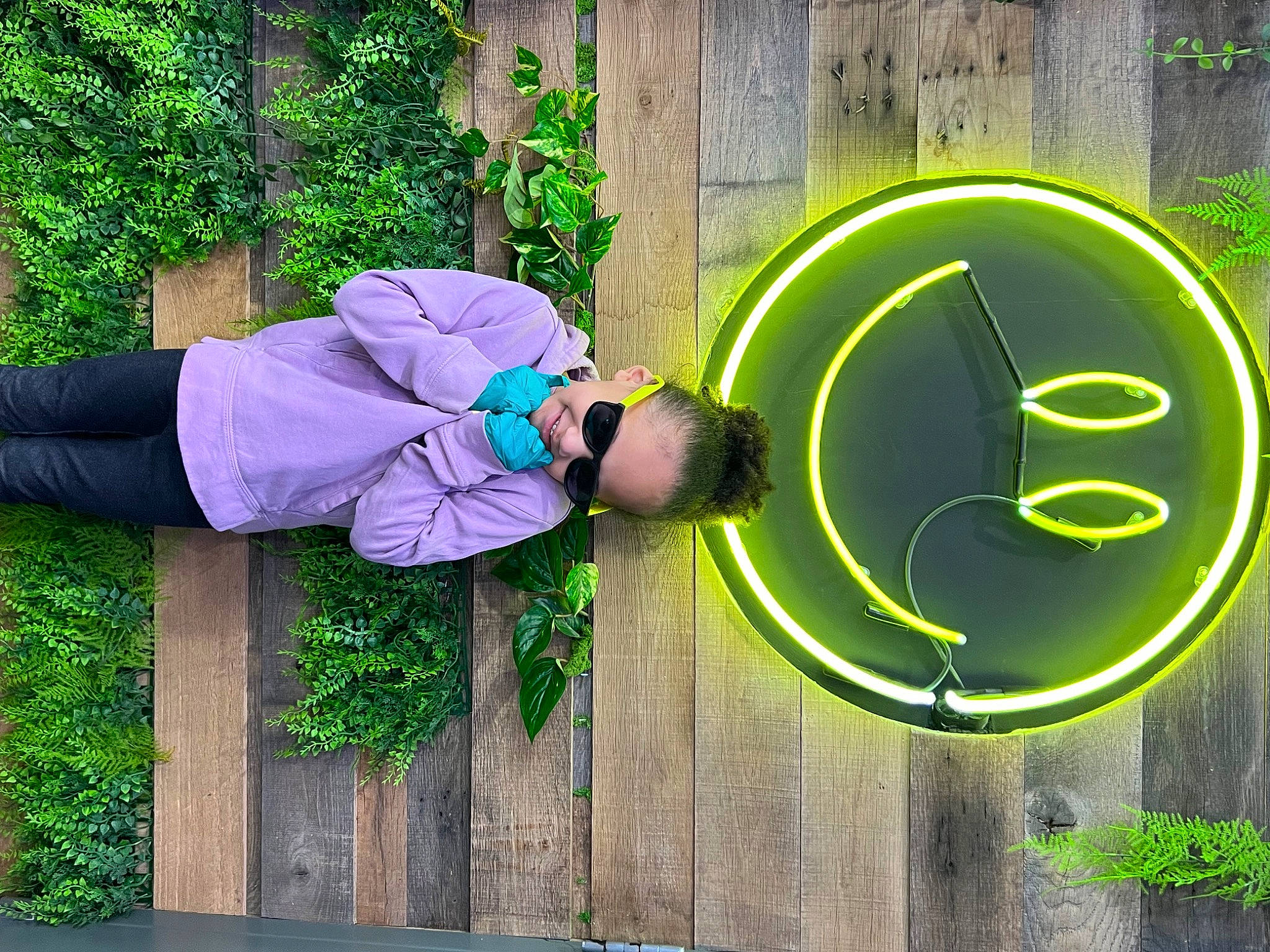 Makyla is registered to the contest to win money with this photo: circle, electric_blue, font, graphics, grass, green, happy, hat, joy, logo, magenta, number, person, plant, sign, signage, sunglasses, t_shirt, wood