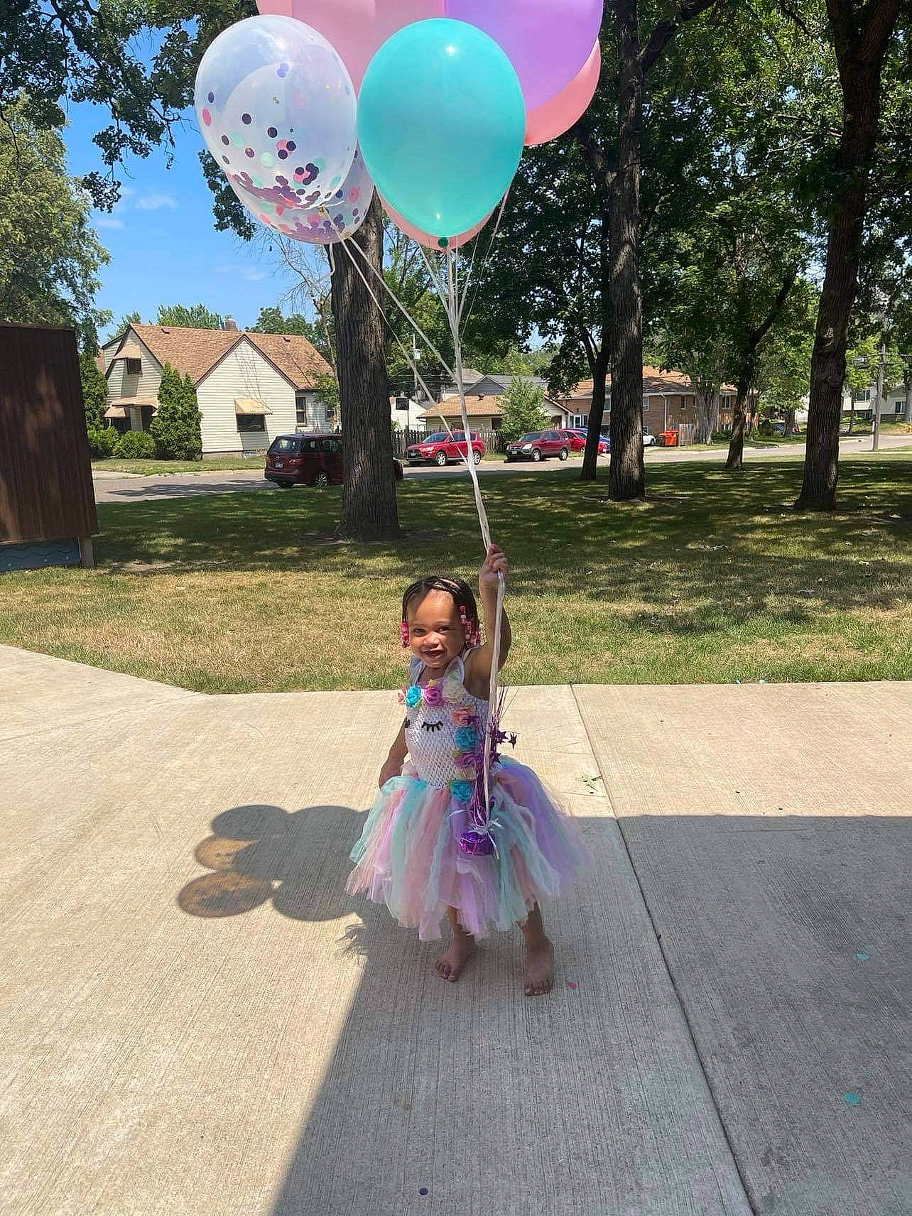 Makyla is registered to the contest to win money with this photo: asphalt, balloon, costume, dress, event, fun, gesture, grass, happy, joy, leisure, magenta, party_supply, person, pink, plant, pole, recreation, sky, summer